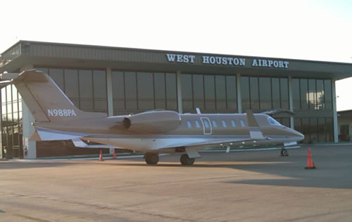 Large brown plane at West Houston Airport